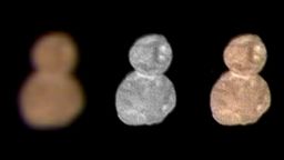The first color image of Ultima Thule, taken at a distance of 85,000 miles (137,000 kilometers) at 4:08 Universal Time on January 1, 2019, highlights its reddish surface. At left is an enhanced color image taken by the Multispectral Visible Imaging Camera (MVIC), produced by combining the near infrared, red and blue channels. The center image taken by the Long-Range Reconnaissance Imager (LORRI) has a higher spatial resolution than MVIC by approximately a factor of five. At right, the color has been overlaid onto the LORRI image to show the color uniformity of the Ultima and Thule lobes. Note the reduced red coloring at the neck of the object. 
