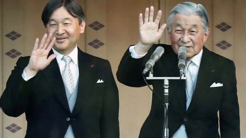 Japan's Emperor Akihito, right, and Crown Prince Naruhito, left, wave to the crowd during the New Year's greeting ceremony at the Imperial Palace in Tokyo on January 2, 2019. 