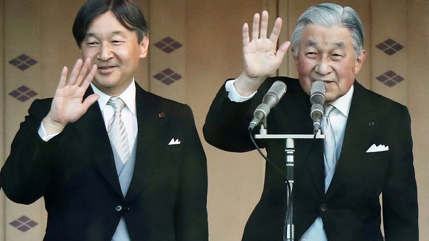 Japan's Emperor Akihito and his successor, Crown Prince Naruhito wave to the crowd during the emperor's New Year's greeting ceremony.