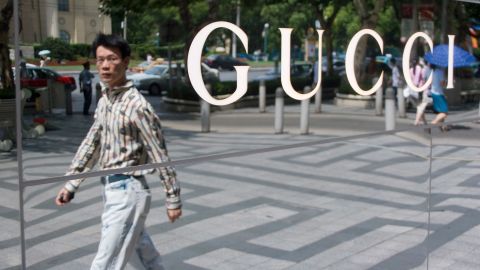 A man walks past a Gucci store in Shanghai.