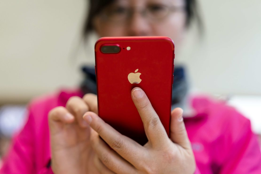 A customer trying a red iPhone 7 in Nanjing, China. Apple on Wednesday said that it expected a weaker Chinese economy to hurt its holiday sales, prompting its stock to plunge.