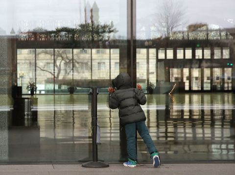 A child looks inside the National Museum of African American History, which was closed because of the shutdown.