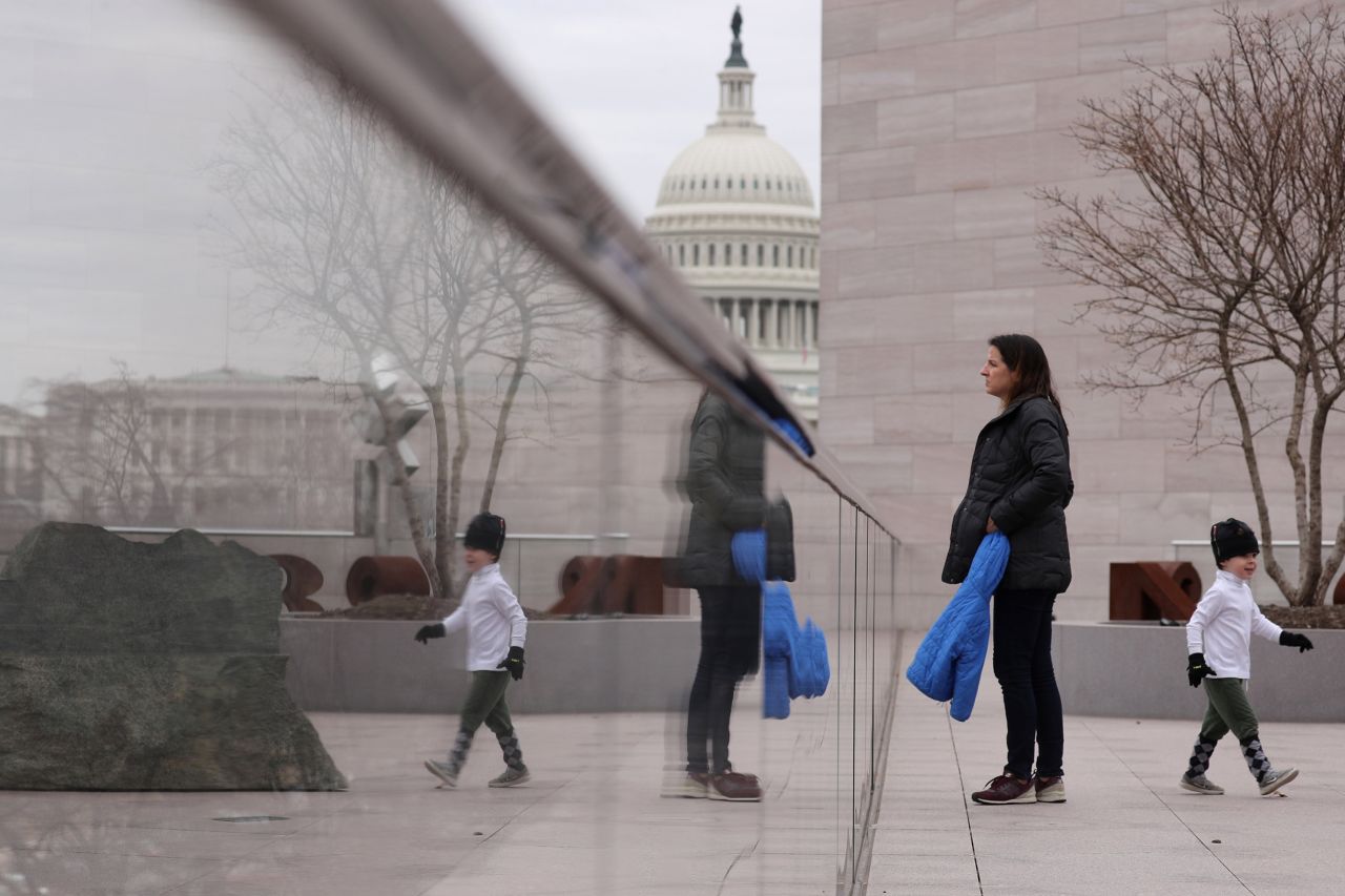 A woman and her child visit the tower deck at the National Gallery of Art in Washington on Wednesday, January 2. It was scheduled to close the next day because of the shutdown.