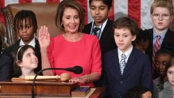 Incoming House Speaker Nancy Pelosi, D-CA, surrounded by children and grandchildren of lawmakers, raises her hand at the closing of the opening of the 116th Congress at the US Capitol in Washington, DC, January 3, 2019. - Veteran Democratic lawmaker Nancy Pelosi was elected speaker of the House Thursday for the second time in her political career, a striking comeback for the only woman ever to hold the post. (Photo by SAUL LOEB / AFP)        (Photo credit should read SAUL LOEB/AFP/Getty Images)