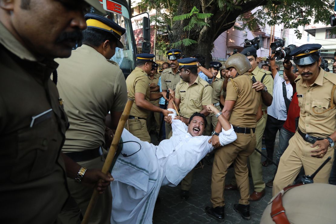 Police carry away a protester in Kochi, Kerala, after two women successfully entered a shrine they were previously barred from visiting. 