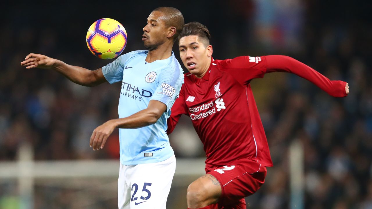 Liverpool's Roberto Firmino challenges Manchester City's Fernandinho during City's 2-1 win in January. 