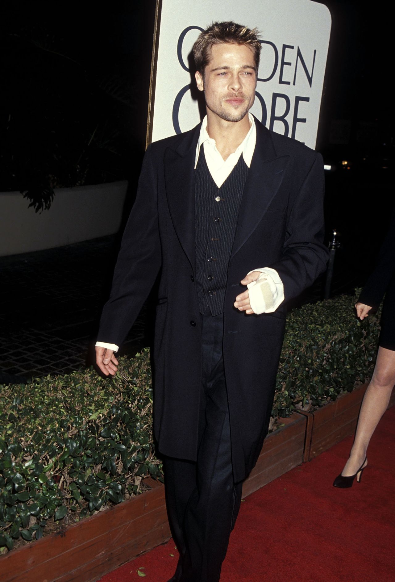 I is for Injury: If anyone can rock a wrist cast on the red carpet it's Brad Pitt (in 1995).