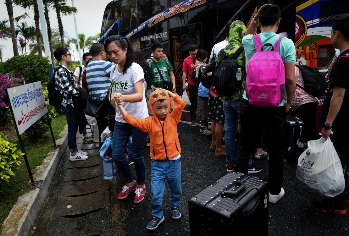 Chinese tourists disembark at Surat Thani airport in southern Thailand after tour operators were forced to suspend boats to tourist islands due to Tropical Storm Pabuk.