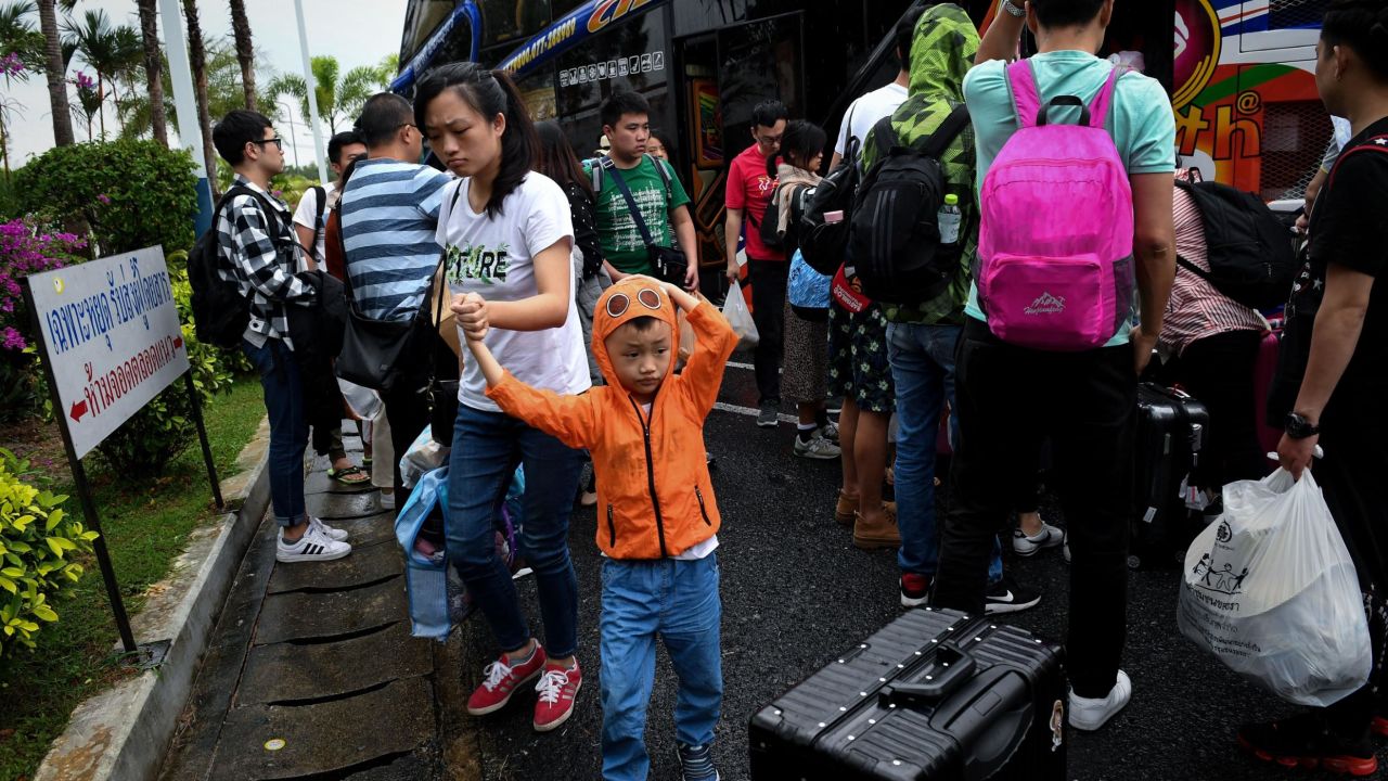 Chinese tourists disembark at Surat Thani airport in southern Thailand after tour operators were forced to suspend boats to tourist islands due to Tropical Storm Pabuk.