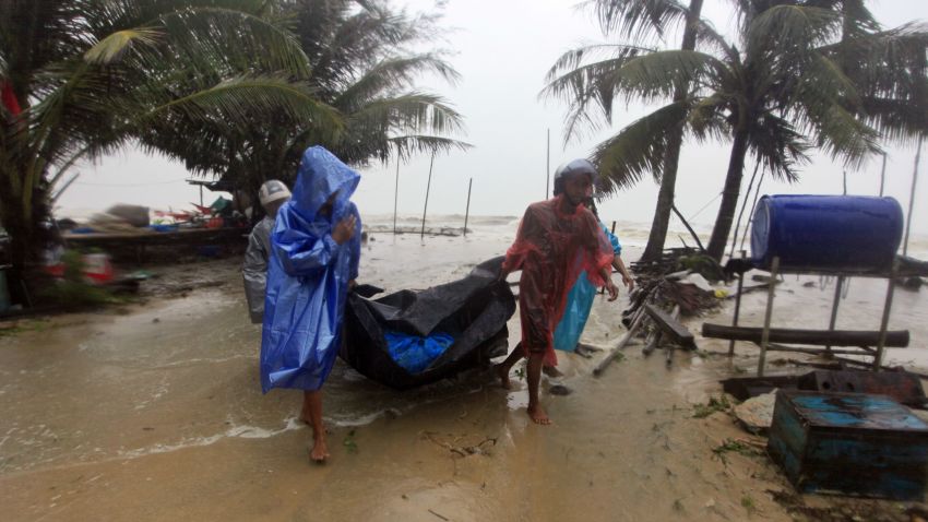 Locals clear the shoreline in preparation for the approaching Tropical Storm Pabuk, Friday, Jan. 4, 2019, in Pak Phanang, in the southern province of Nakhon Si Thammarat, southern Thailand. Rain, winds and surging seawater are striking southern Thailand as a strengthening tropical storm nears coastal villages and popular tourist resorts. (AP Photo/Sumeth Panpetch)