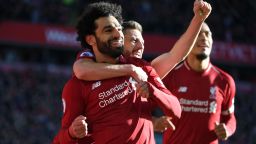 Liverpool's Egyptian midfielder Mohamed Salah (L) celebrates scoring the opening goal with Liverpool's English midfielder Adam Lallana (R) during the English Premier League football match between Liverpool and Cardiff City at Anfield in Liverpool, north west England on October 27, 2018. (Photo by Paul ELLIS / AFP) / RESTRICTED TO EDITORIAL USE. No use with unauthorized audio, video, data, fixture lists, club/league logos or 'live' services. Online in-match use limited to 120 images. An additional 40 images may be used in extra time. No video emulation. Social media in-match use limited to 120 images. An additional 40 images may be used in extra time. No use in betting publications, games or single club/league/player publications. /         (Photo credit should read PAUL ELLIS/AFP/Getty Images)