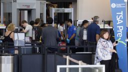 Travelers carry baggage for screening at a Transportation Security Administration (TSA) checkpoint at Los Angeles International Airport (LAX) in Los Angeles, California, U.S., on Thursday, Oct. 25, 2018. A new LAX policy will allow travelers to possess a small amount of marijuana inside the airport, and on planes, if the traveler is flying to a state where weed is legal. Photographer: Patrick T. Fallon/Bloomberg via Getty Images
