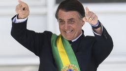 Brazil's new president Jair Bolsonaro gestures after receiving the presidential sash from outgoing Brazilian president Michel Temer (out of frame), at Planalto Palace in Brasilia on January 1, 2019. - Bolsonaro takes office with promises to radically change the path taken by Latin America's biggest country by trashing decades of centre-left policies. (Photo by EVARISTO SA / AFP)        (Photo credit should read EVARISTO SA/AFP/Getty Images)