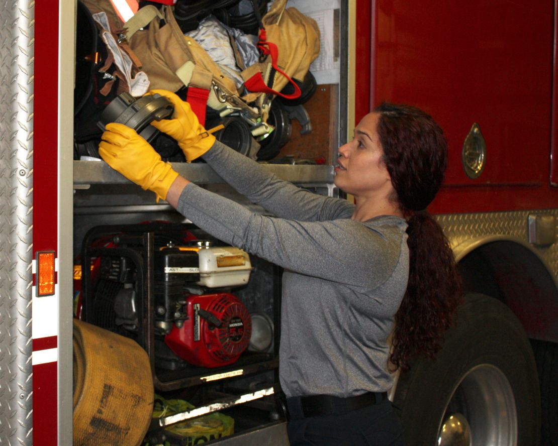 Vivi Rodriguez, a firefighter/paramedic with a large city fire department, wears SeeHerWork gloves on the job.