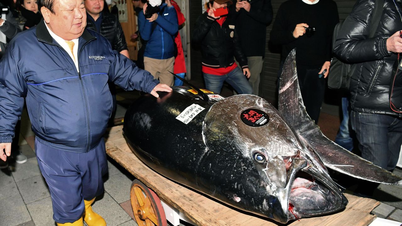 Kiyoshi Kimura, the "Tuna King," stands with the bluefin tuna that reached a record price at the 2019 New Year's auction.