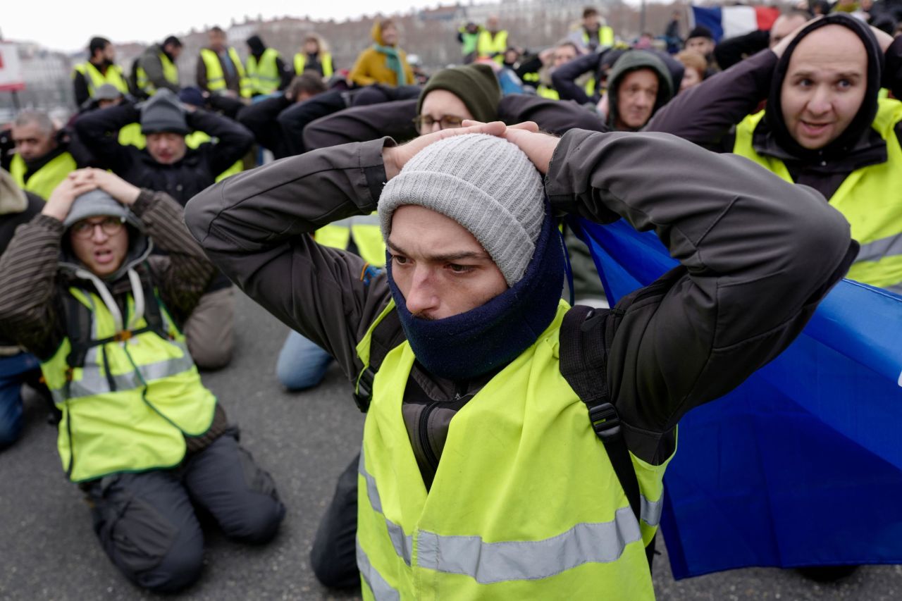 Yellow vest protestors kneel in Lyon on January 5. About 50,000 people demonstrated throughout France on Saturday, according to Interior Minister Christophe Castaner.