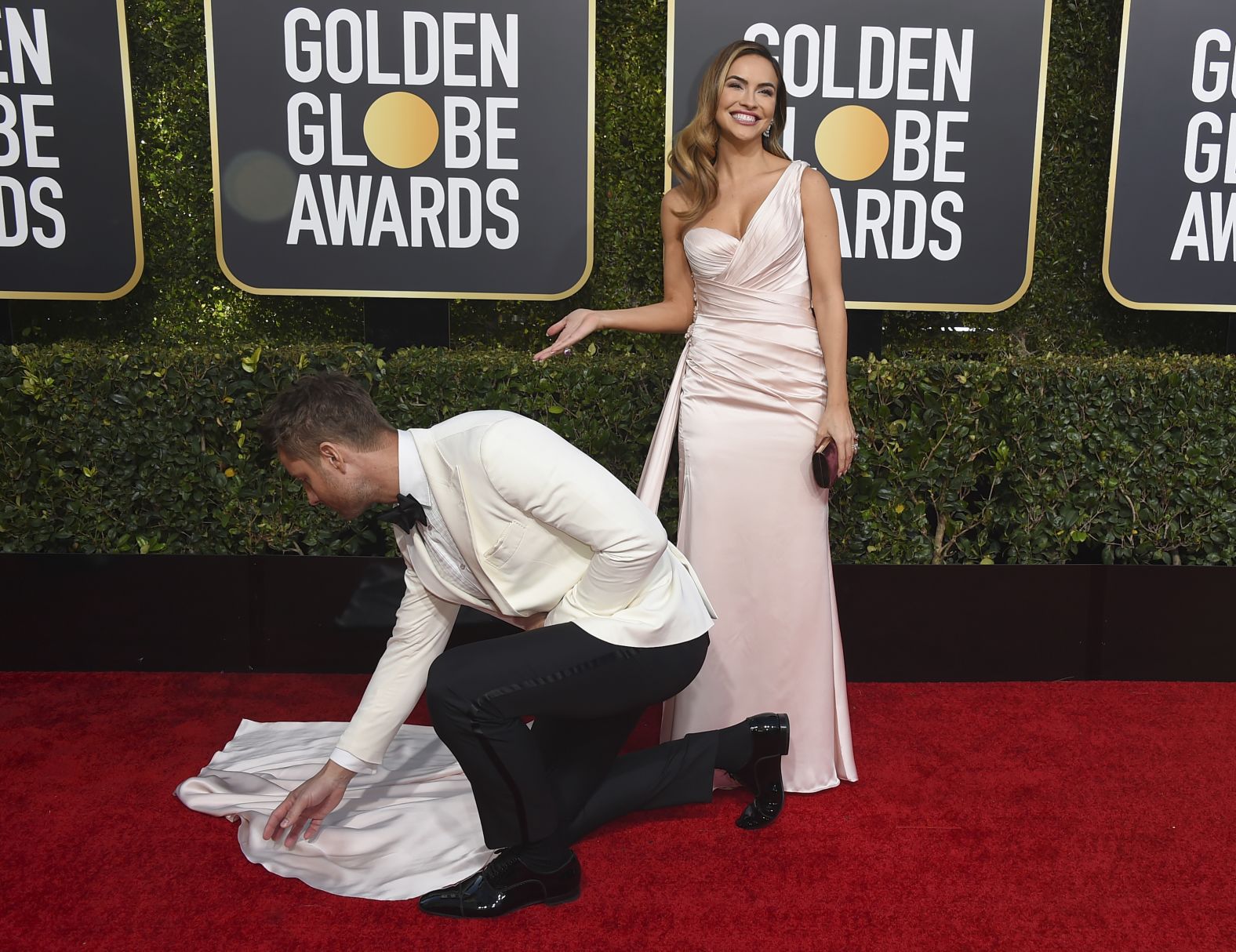 Justin Hartley adjusts the dress of his wife, Chrishell Stause.