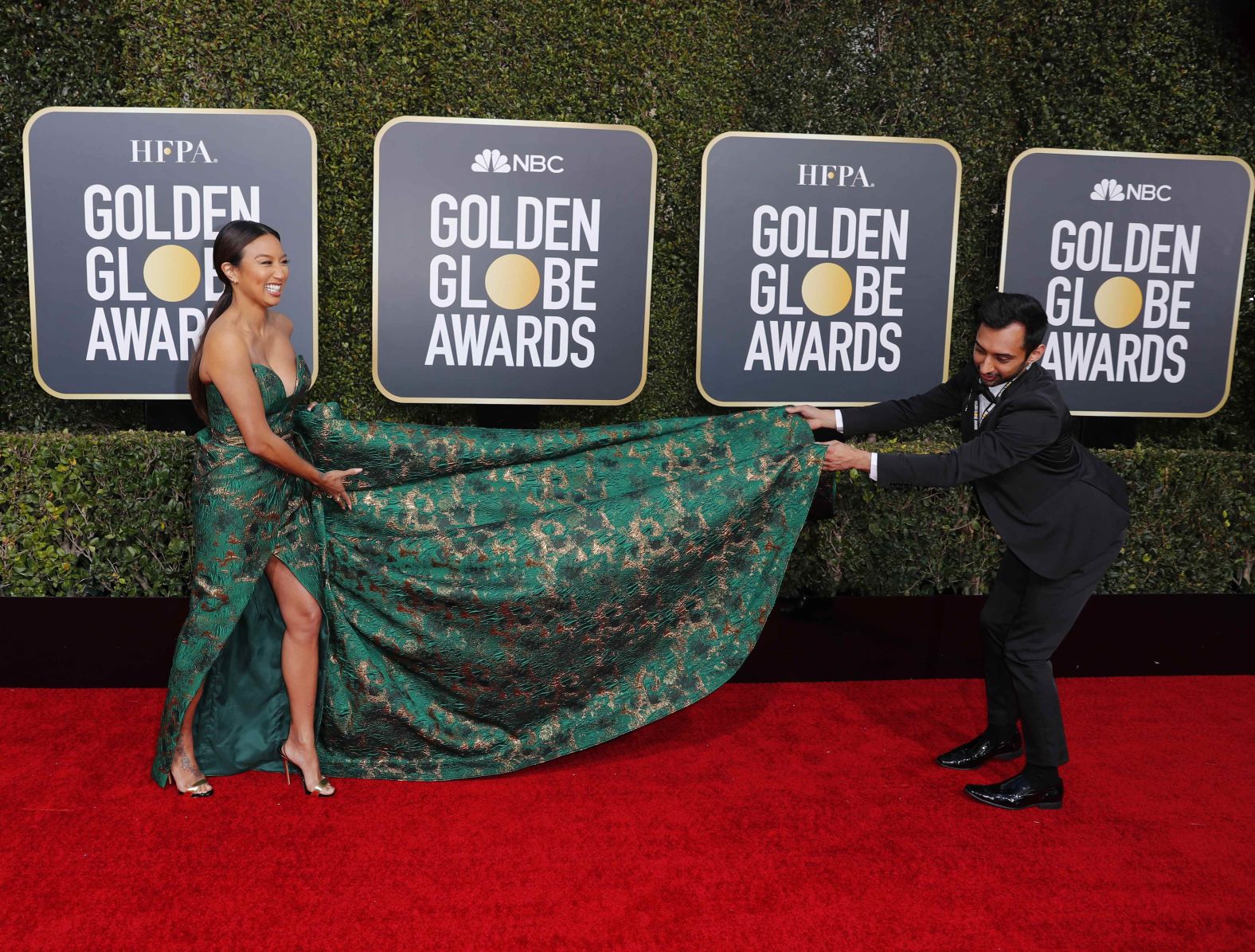 Jeannie Mai gets some help with her dress.