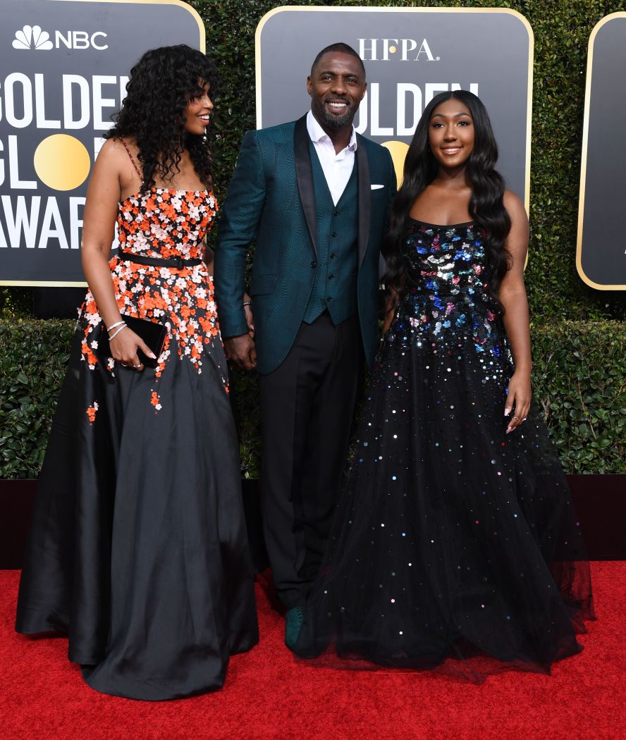 Idris Elba walks the red carpet with his fiancee, Sabrina Dhowre, and his daughter, Isan. Isan, right, is a Golden Globes ambassador this year.