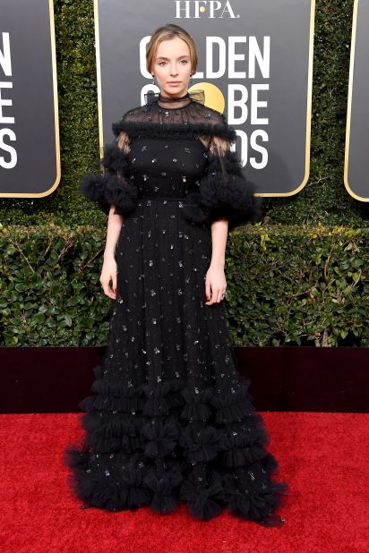 Jodie Comer, who plays the stylish assassin Villanelle in "Killing Eve," appeared to coordinate a good-guy-bad-guy ensemble with co-star Sandra Oh, wearing a black tulle Ralph & Russo gown with layered ruffles to contrast with Oh's white ensemble.