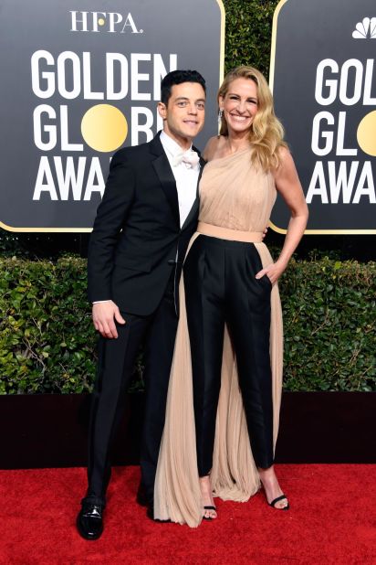 "Bohemian Rhapsody" star Rami Malek opted for a white bowtie with an otherwise traditional tuxedo. "Homecoming" star Julia Roberts wore a one-shoulder, glittering Stella McCartney pantsuit. 