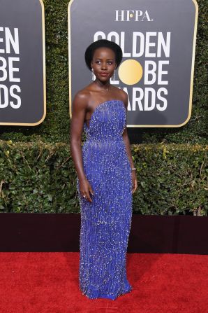 Lupita Nyong'o wore a custom cobalt blue dress with silver drop beads by Calvin Klein.