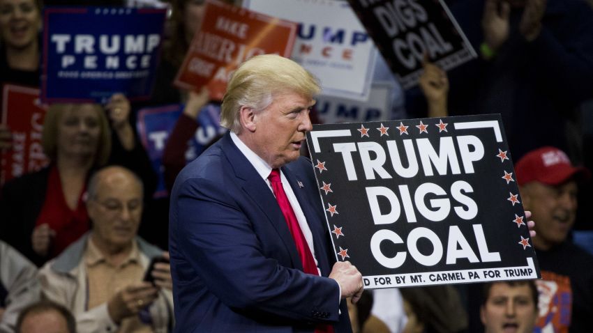 Republican presidential nominee Donald Trump  holds a sign supporting coal during a rally at Mohegan Sun Arena in Wilkes-Barre, Pennsylvania on October 10, 2016.