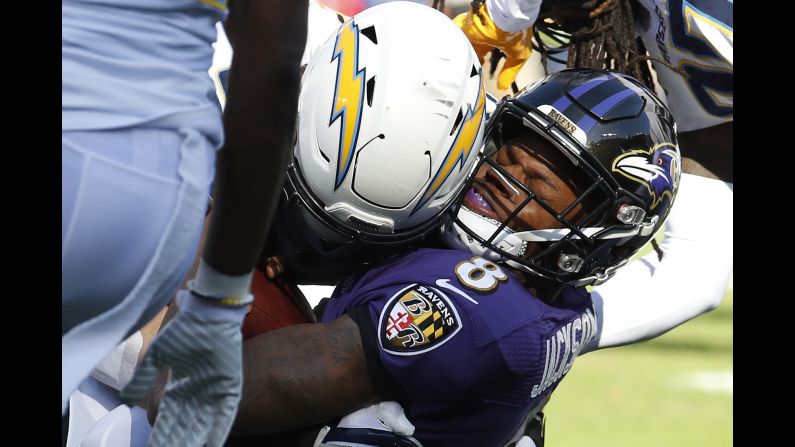 Baltimore's Lamar Jackson is crunched by Los Angeles Chargers defensive end Joey Bosa during an NFL playoff game on Sunday, January 6. The Chargers frustrated the rookie quarterback for much of the afternoon as they defeated the Ravens 23-17.