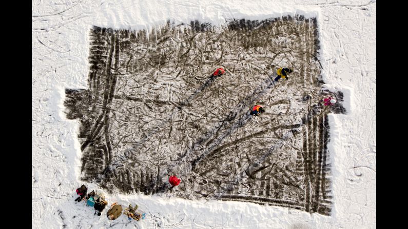 People play hockey on a frozen lake in La Brevine, Switzerland, on Friday, January 4.