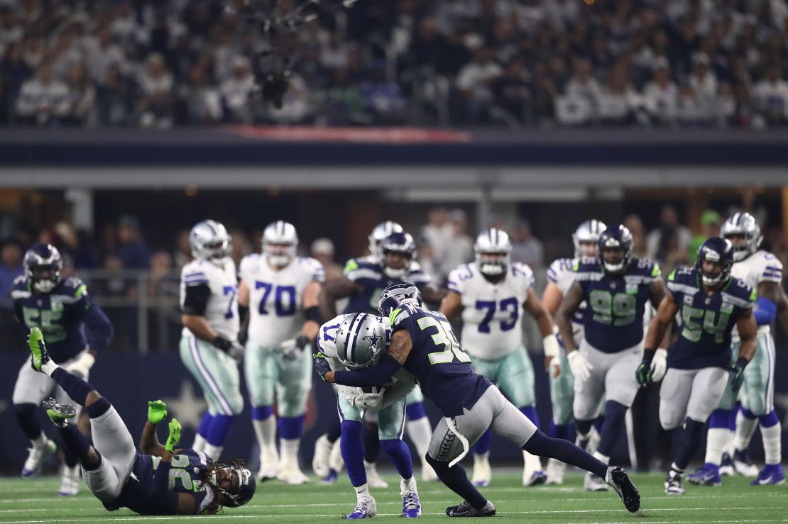 Dallas Cowboys' Allen Hurns suffers a leg injury when tackled by Seattle's Bradley McDougald.