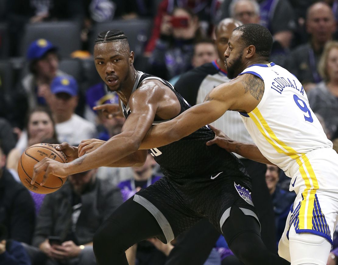 Golden State Warriors guard Andre Iguodala reaches in for the ball held by Sacramento Kings forward Harry Giles III.