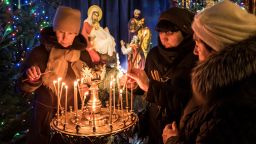 KIEV, UKRAINE - JANUARY 06: Worshippers ight candles during Christmas services at St. Michael's Golden-Domed Monastery, the main church of the new Orthodox Church of Ukraine, on January 6, 2019 in Kiev, Ukraine. The independent Orthodox Church of Ukraine, which previously fell under the authority of Moscow, was granted official recognition today in a decree, or "tomos," signed by the Ecumenical Patriarch of Constantinople in a move with deep historical roots but fueled by contemporary political conflict between Ukraine and Russia. (Photo by Brendan Hoffman/Getty Images)