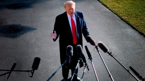 US President Donald Trump speaks to the press as he departs the White House in Washington, DC, on January 6, 2019, for meetings at Camp David. - President Donald Trump stood firm Sunday on his demand for billions of dollars to fund a border wall with Mexico, which has forced a shutdown of the US government now entering its third week."We have to build the wall," Trump told reporters as he left the White House for the Camp David presidential retreat, while conceding that the barrier could be "steel instead of concrete." (Photo by Jim WATSON / AFP) (Photo credit should read JIM WATSON/AFP/Getty Images)