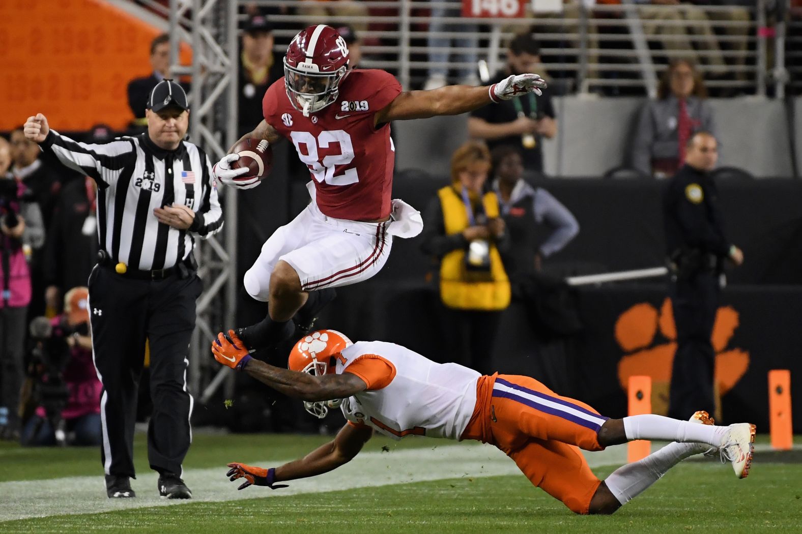 Alabama's Irv Smith Jr. leaps over a tackle from Trayvon Mullen in the first quarter.