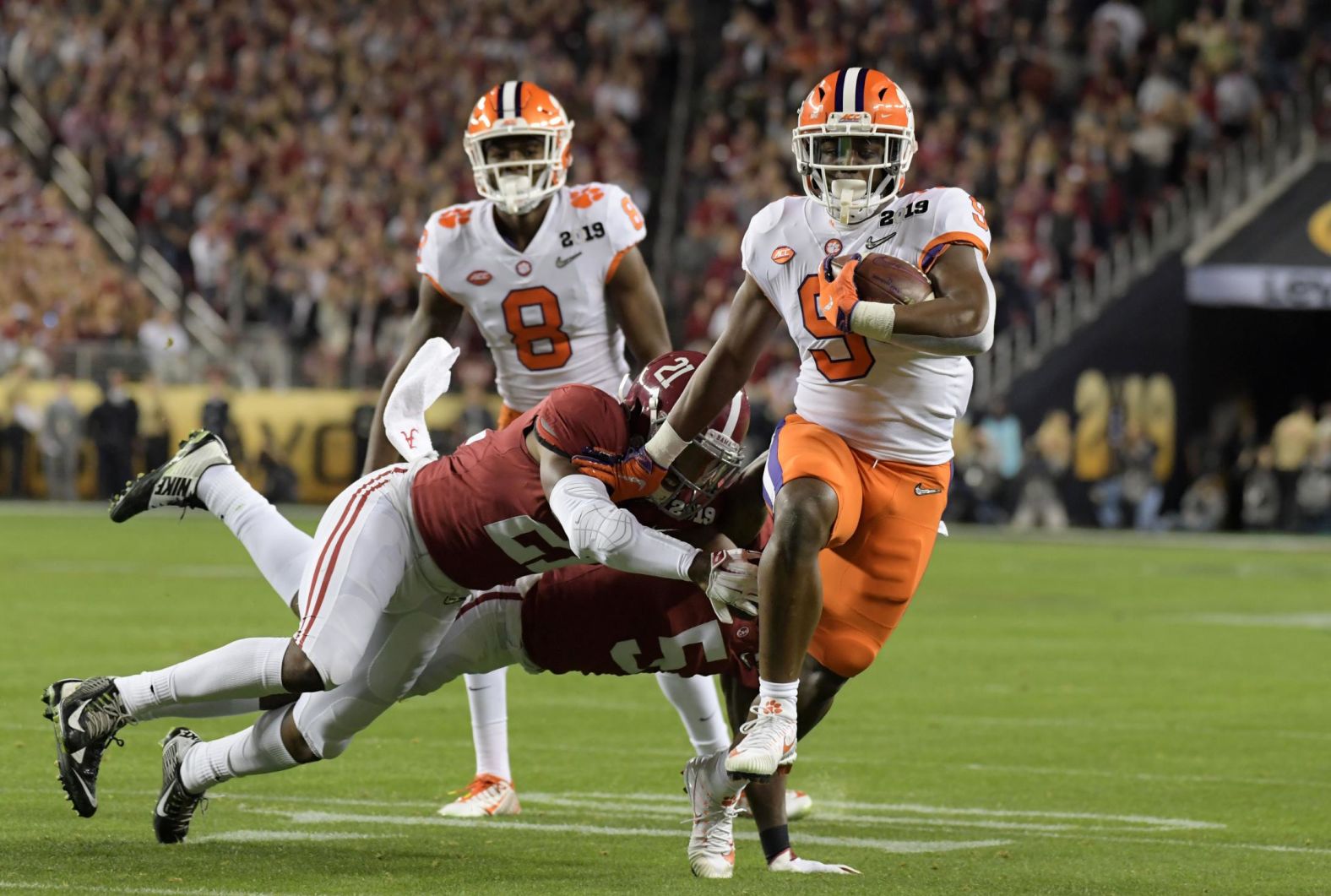 Etienne eludes Alabama defenders on his way to a 17-yard touchdown run in the first quarter. The Tigers led 14-7 after the extra point.