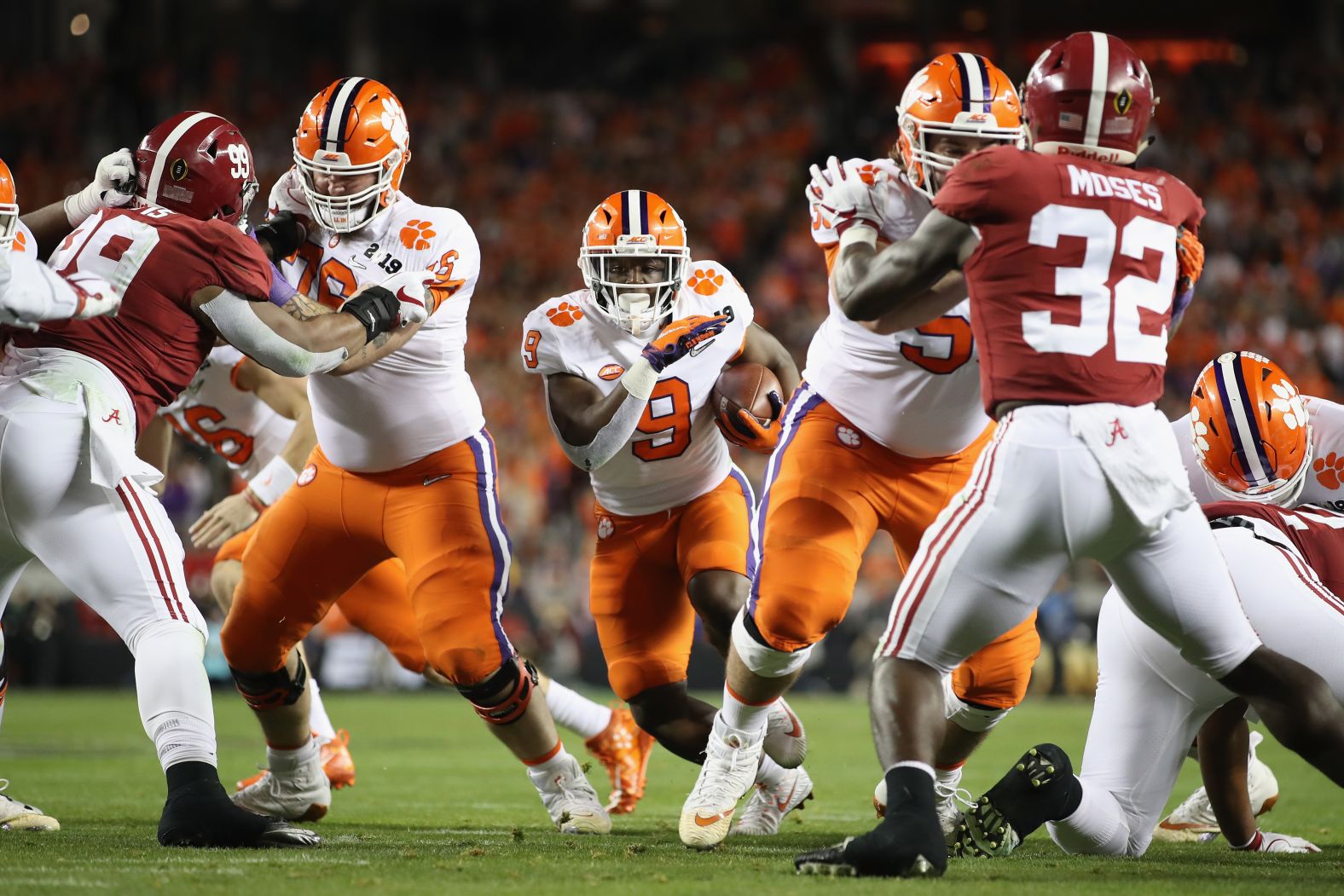 Clemson running back Travis Etienne runs for one of his three first-half touchdowns. His third gave the Tigers a 28-16 lead, and they added a field goal to lead 31-16 at halftime.