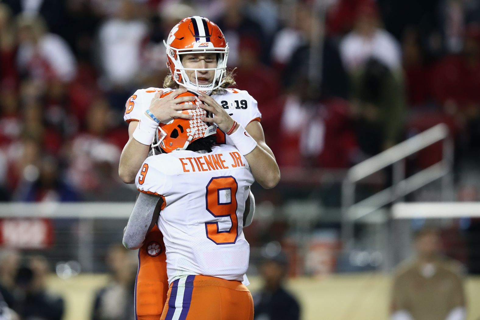 Etienne celebrates one of his first-half touchdowns with Lawrence.