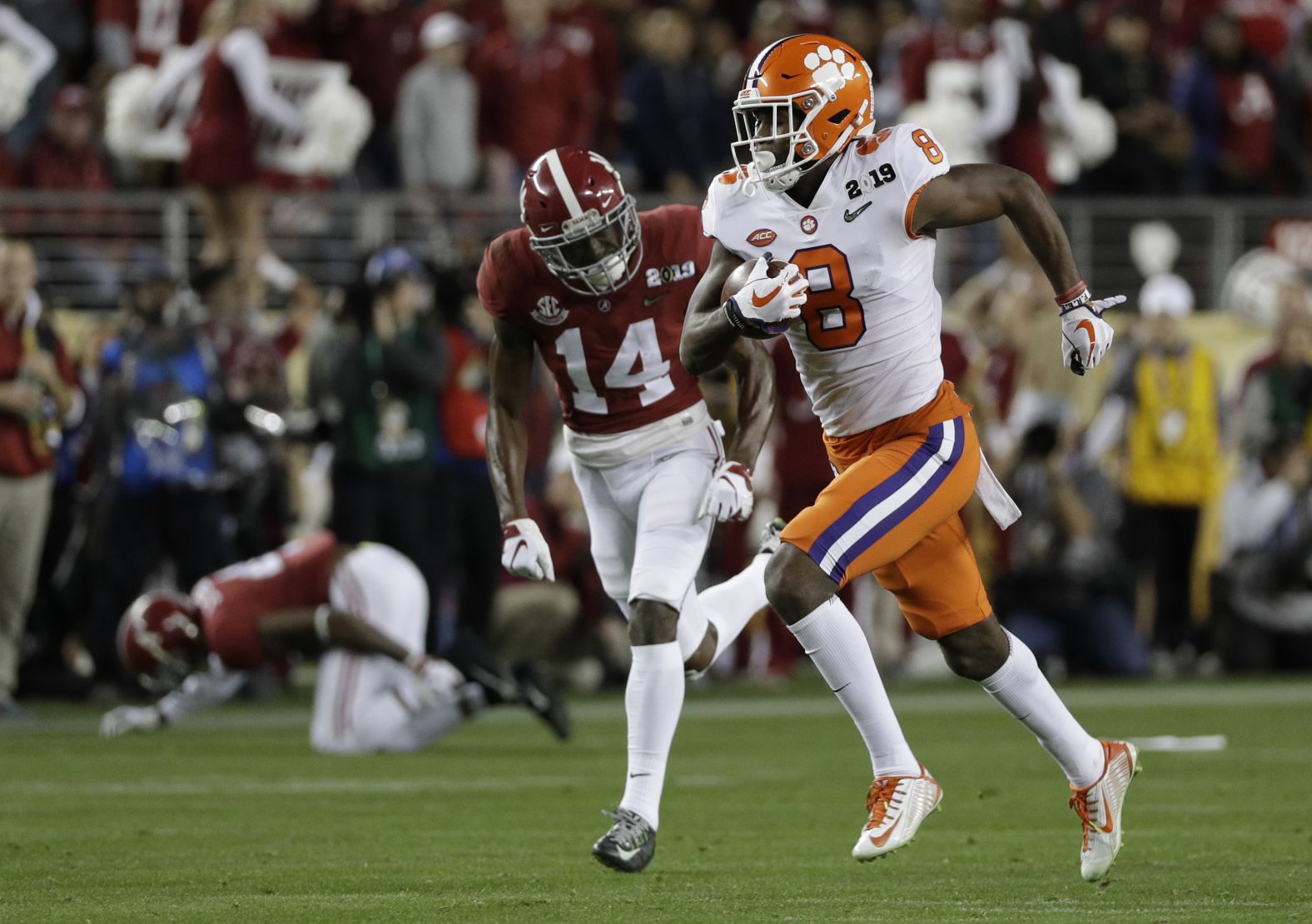 Ross sprints away from the Alabama defense for his touchdown. At left is defensive back Saivion Smith, who went down hurt on the play.