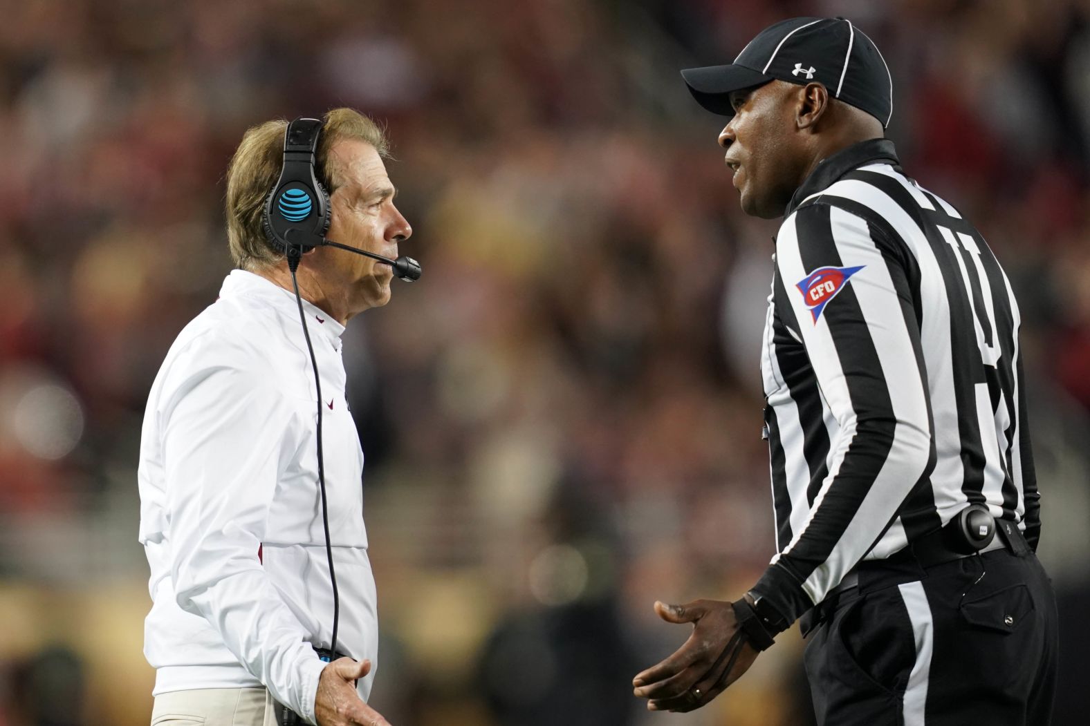 Saban speaks to an official during the third quarter.