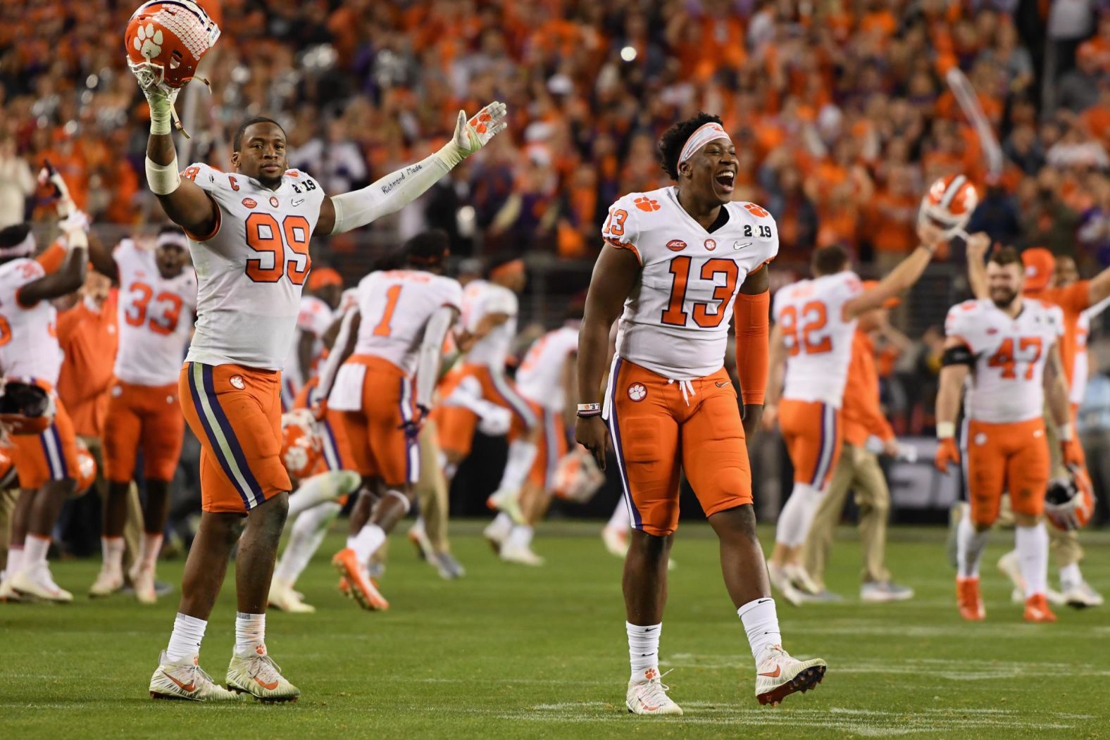 Clemson players, including Clelin Ferrell (No. 99) and Hunter Renfrow (No. 13), run onto the field to celebrate.