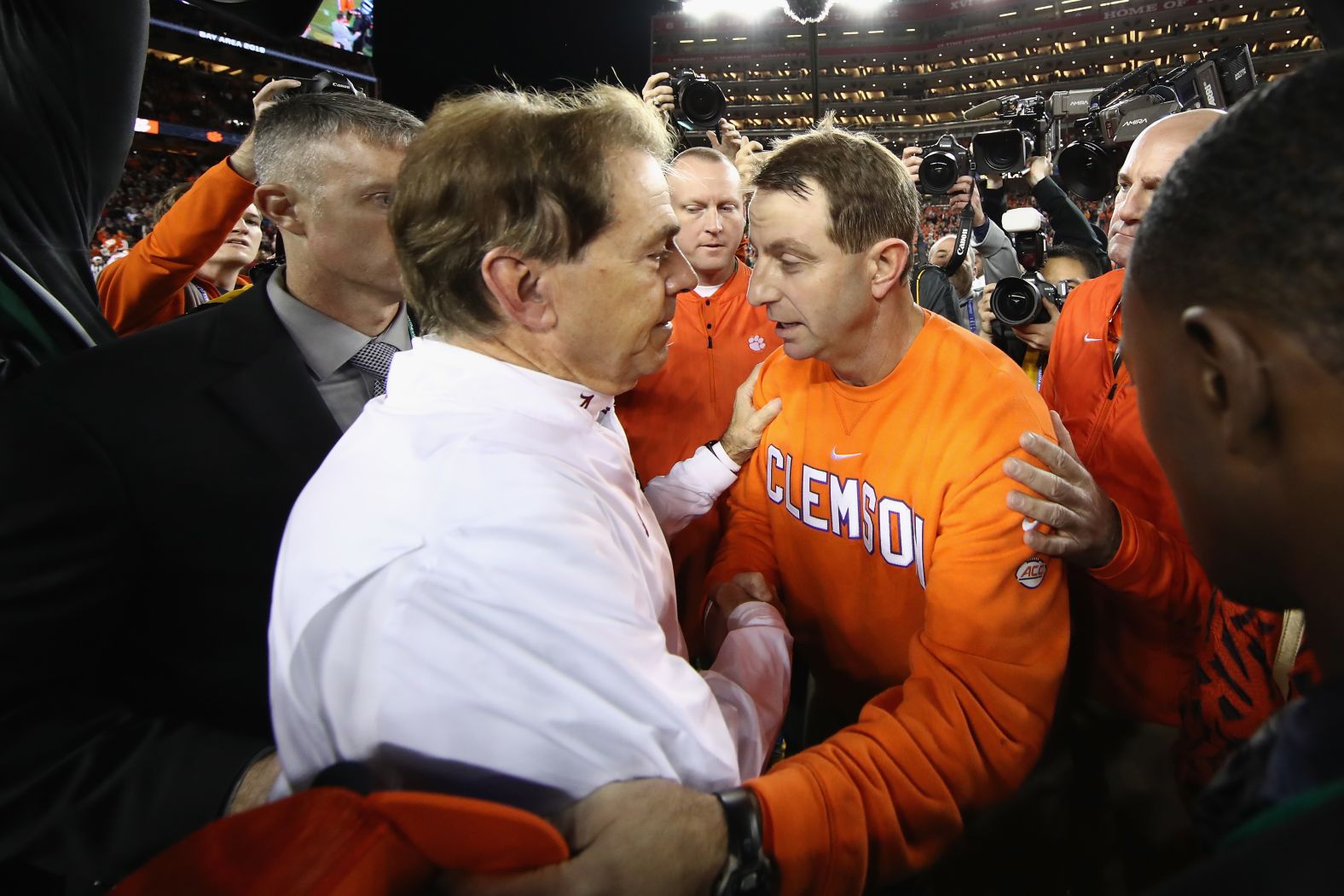 Alabama head coach Nick Saban, left, shakes hands with Clemson head coach Dabo Swinney.