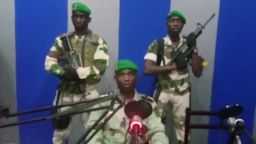 In this image from TV, a soldier who identified himself as Lt. Obiang Ondo Kelly, commander of the Republican Guard, reads a statement on state television broadcast from Libreville, saying the military has seized control of the government, Monday Jan. 7, 2019.  The statement said Soldiers from Gabon's Republican Guard have launched a coup "to restore democracy" in the West African country, while imposing a curfew in the capital, and the internet has been cut.  No violence has been reported and President Ali Bongo has been out of the country since October amid reports that he had a stroke.(Gabon State TV via AP)