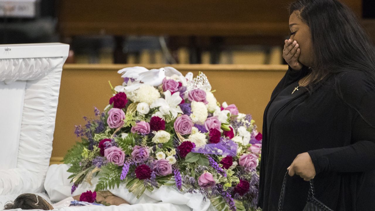 A mourner approaches Jazmine's casket during a viewing Tuesday.