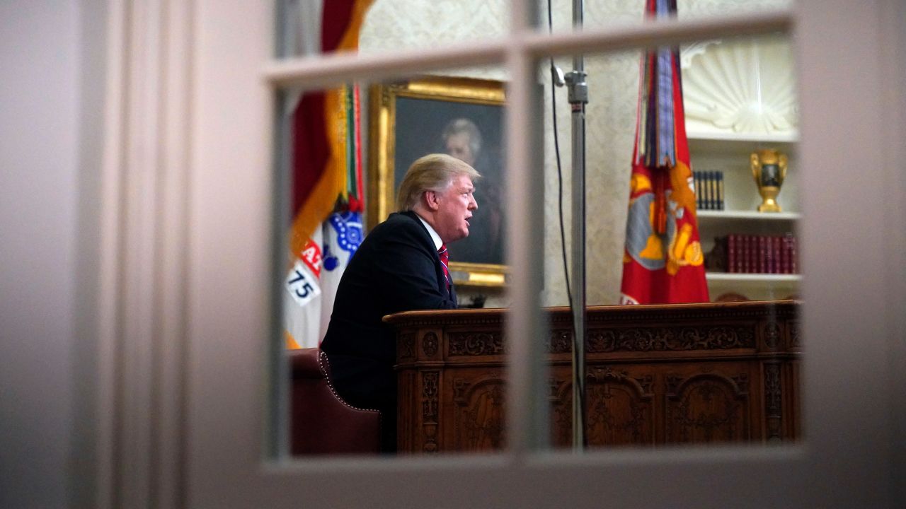 As seen from a window outside the Oval Office, President Donald Trump gives a prime-time address about border security Tuesday, Jan. 8, 2018, at the White House in Washington. (AP Photo/Carolyn Kaster)