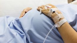 Asian Pregnant Woman patient is on drip receiving a saline solution on bed VIP room at hospital, selective focus.; Shutterstock ID 451515829; Job: -