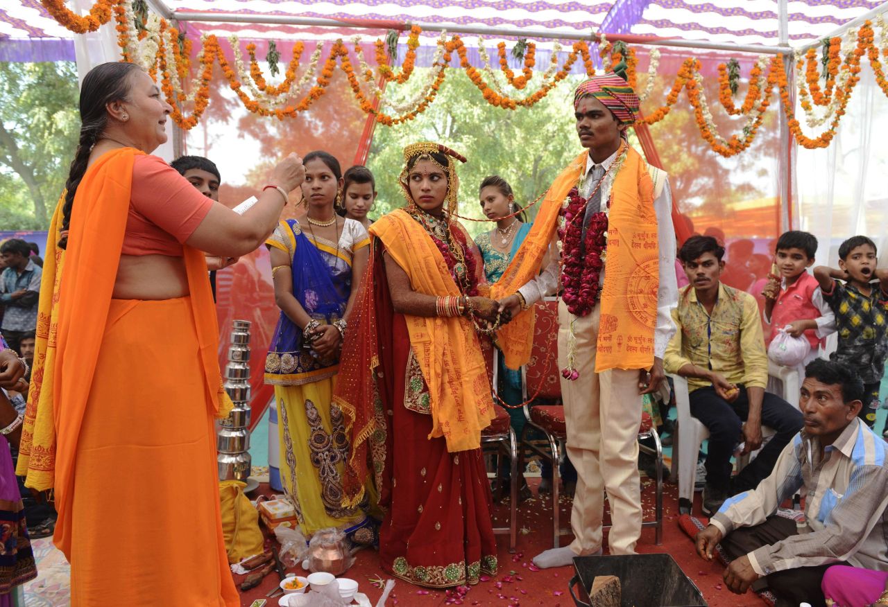 An Indian bride and groom take part in a ceremony during a mass wedding on the outskirts of Ahmedabad, Gujarat.