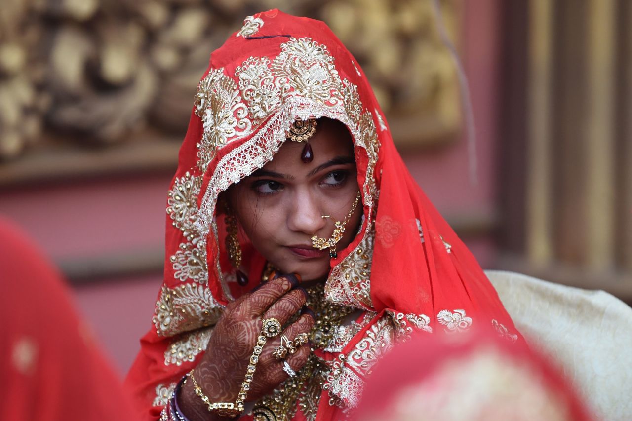 An Indian Muslim bride looks on as she participates in a mass marriage in Ahmedabad, Gujarat, in December 2018. Some 65 Muslim couples wed at the ceremony.