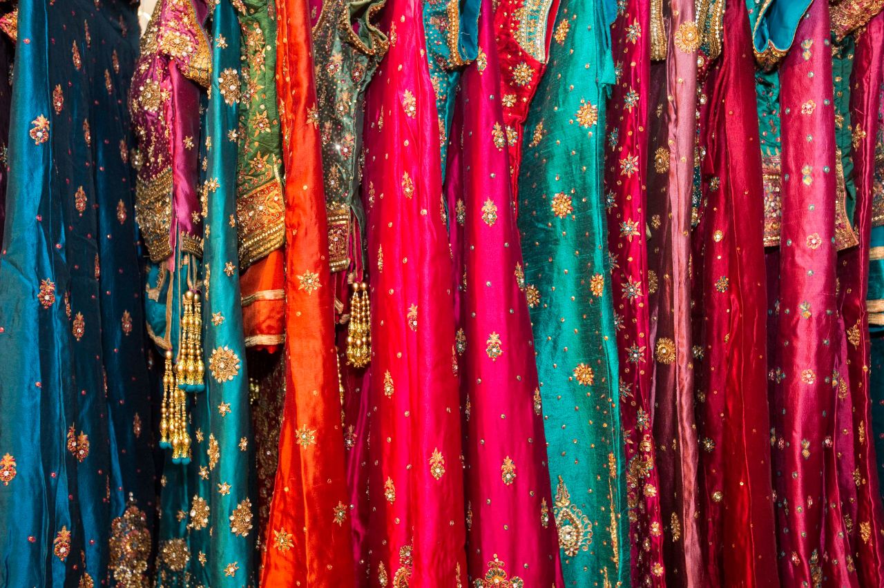 Traditional Rajasthani garments hang inside a bridal wear shop.
