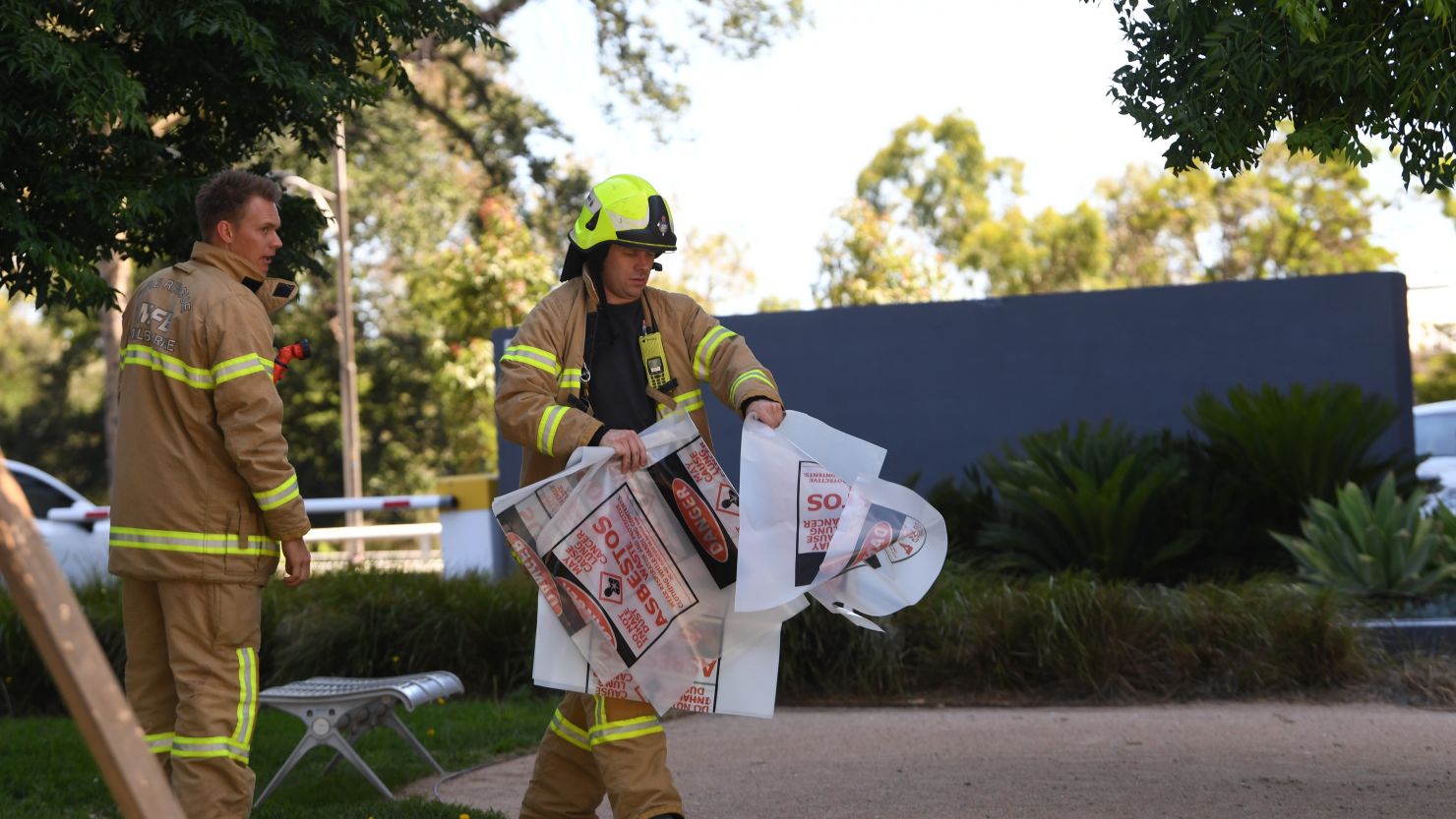 A firefighter carries a hazardous material bag into the Korean Consulate in Melbourne on Wednesday. 