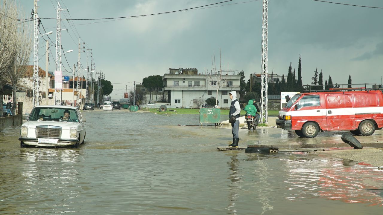 Cars on the road near the refugee camps in the Bar Elias area drive through half a meter of water. 